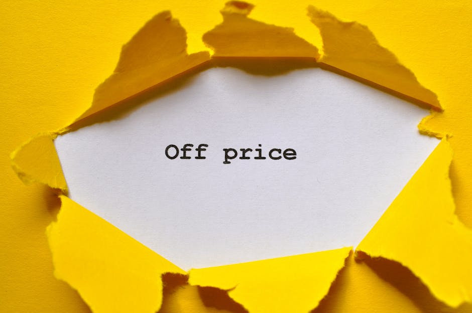 A close-up photograph of a torn yellow paper with rough, jagged edges revealing a white surface underneath. In the center of the exposed white area, the words 'Off price' are printed in a simple black